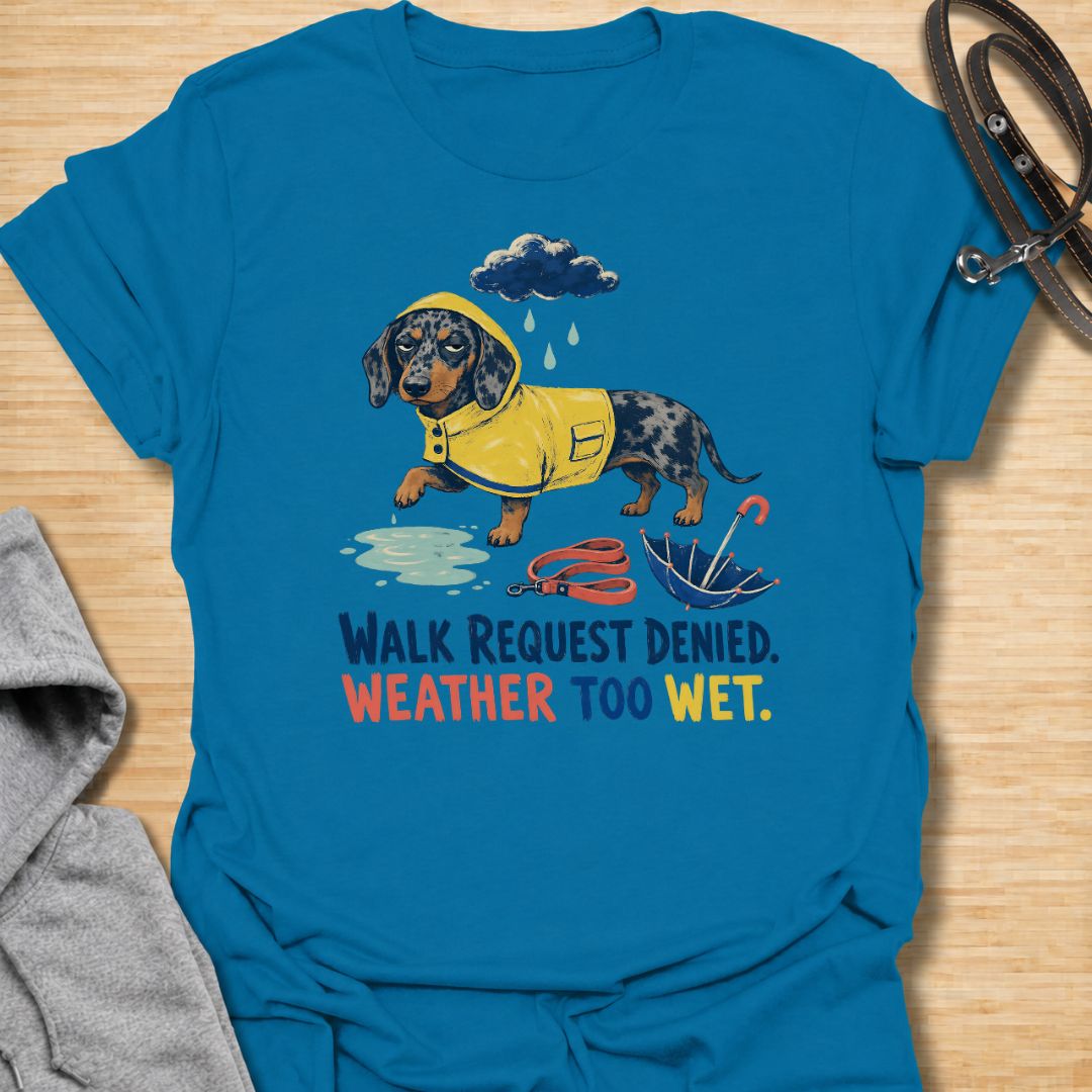 Celebrate a dachshund’s selective approach to outdoor adventures with this funny “Walk Request Denied, Weather Too Wet” T-shirt. Featuring a raincoat-wearing doxie beside a puddle, umbrella, and leash, it is perfect for dachshund moms, dog dads, and sausage dog lovers. A playful gift for anyone whose stubborn little dog refuses to walk in the rain.