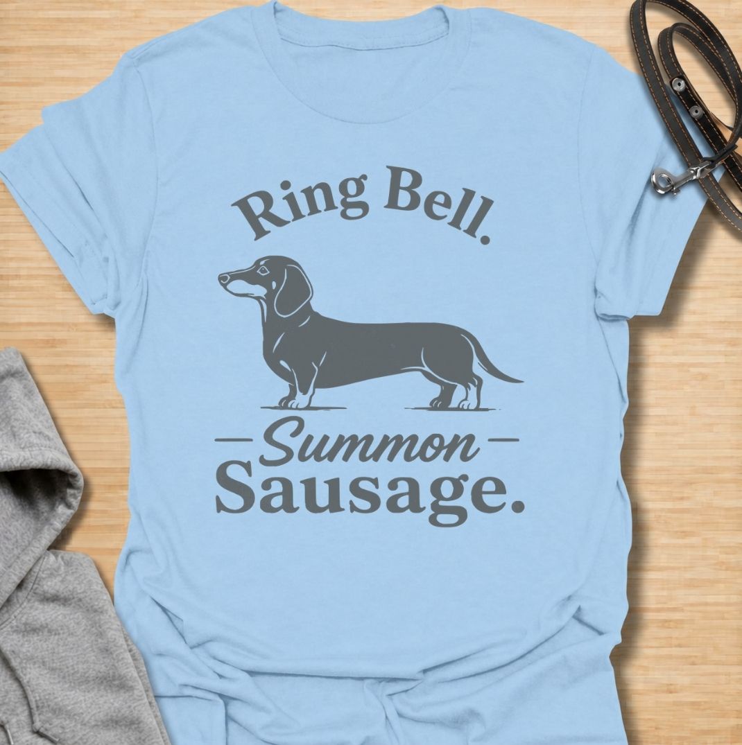 Ring bell, summon sausage. A funny dachshund T-shirt for sausage dog owners who know the doorbell instantly activates their little household alarm.