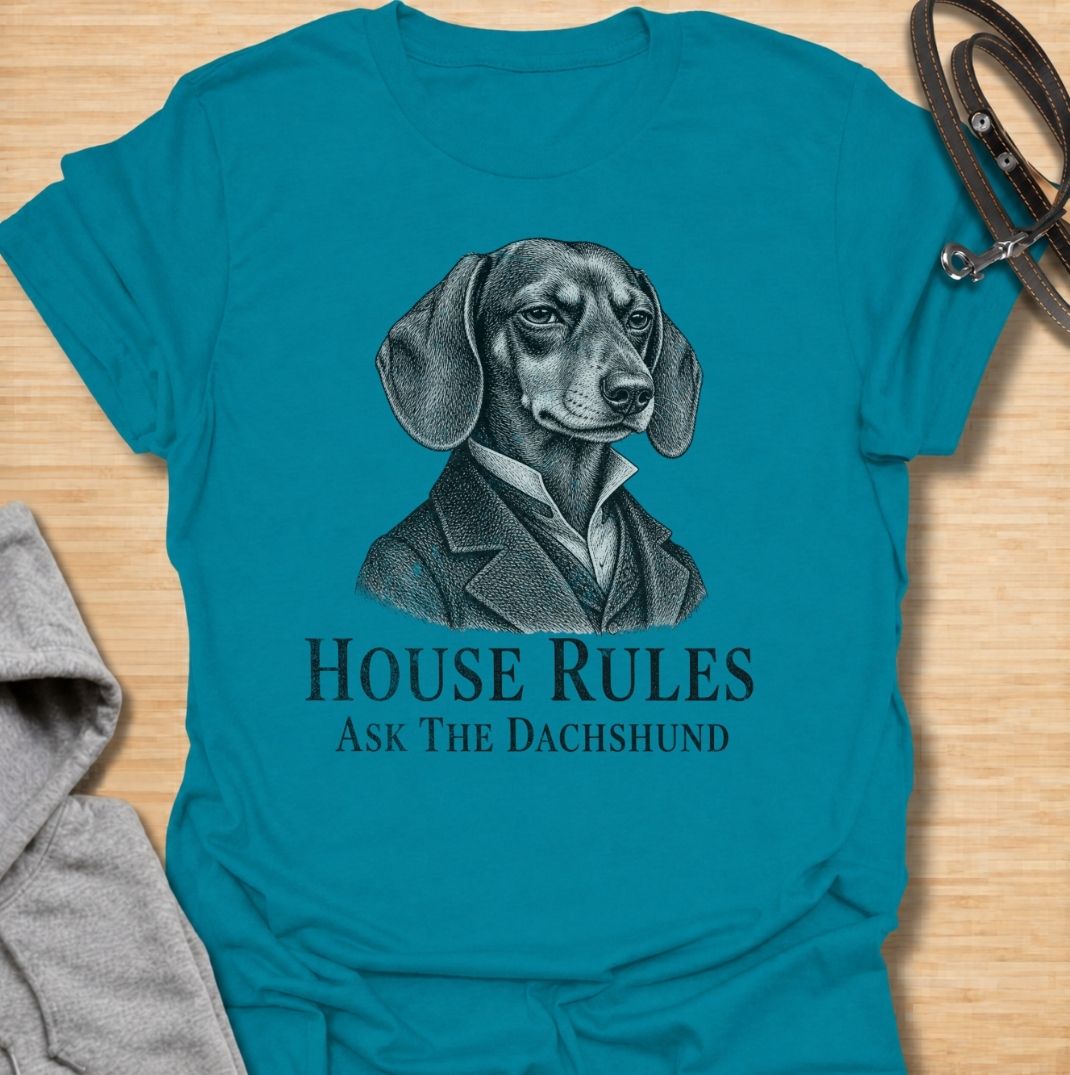 A funny dachshund T-shirt for anyone who knows exactly who really makes the rules at home. Featuring a distinguished vintage-style dachshund portrait with the phrase “House Rules — Ask The Dachshund,” this design gives classic artwork a playful dog-owner twist. Perfect for dachshund moms, dachshund dads, sausage dog lovers, and anyone living under the authority of a very opinionated little dog. A quirky everyday tee for fans of dachshund humor, vintage dog art, and breed-specific gifts.