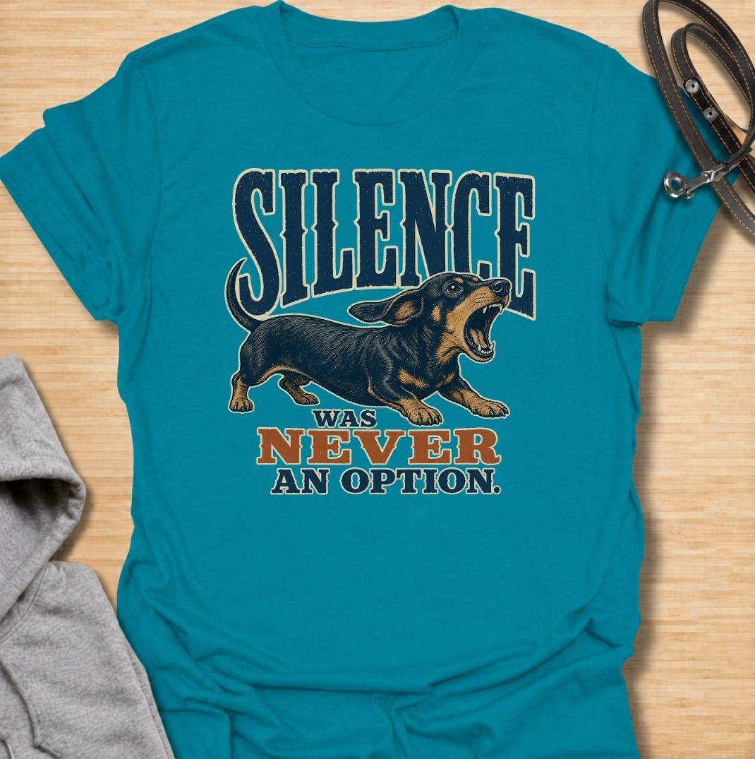A funny dachshund T-shirt for anyone who knows silence is rarely part of life with a sausage dog. Featuring the phrase “Silence Was Never an Option” with a barking dachshund illustration, this design captures the breed’s loud, opinionated personality perfectly. Ideal for dachshund moms, dachshund dads, wiener dog owners, and anyone whose little dog always has something to say. A bold everyday tee for fans of dachshund humor, noisy dogs, and small dogs with very big voices.