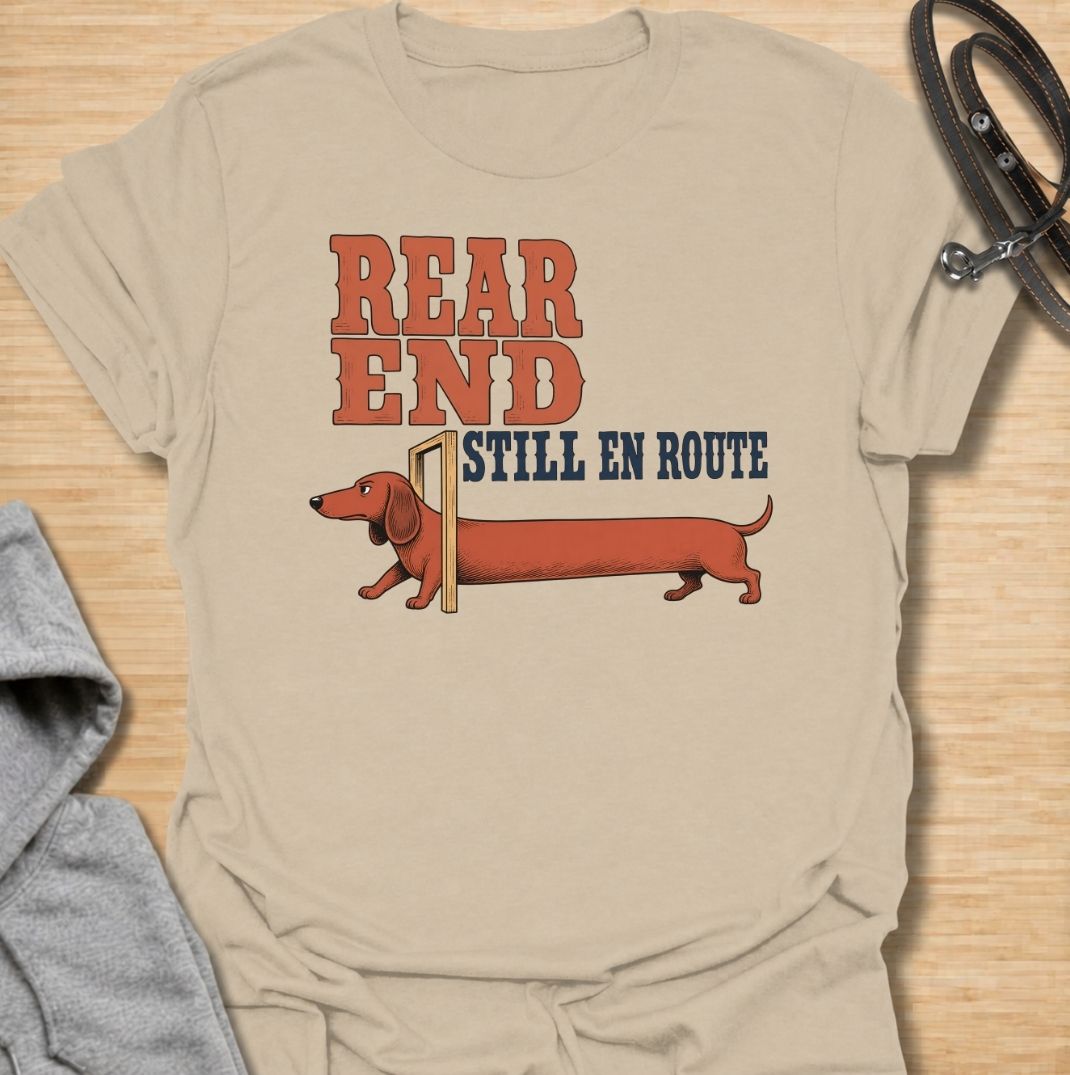 A funny dachshund T-shirt for anyone who knows a sausage dog can seem to arrive in two separate installments. Featuring the phrase “Rear End Still En Route” with a stretched-out dachshund illustration, this design makes the most of the breed’s famously long body. Perfect for dachshund moms, dachshund dads, wiener dog owners, and anyone who loves dry breed-specific humor. A playful everyday tee for fans of dachshunds, sausage dogs, and quirky dog gifts.