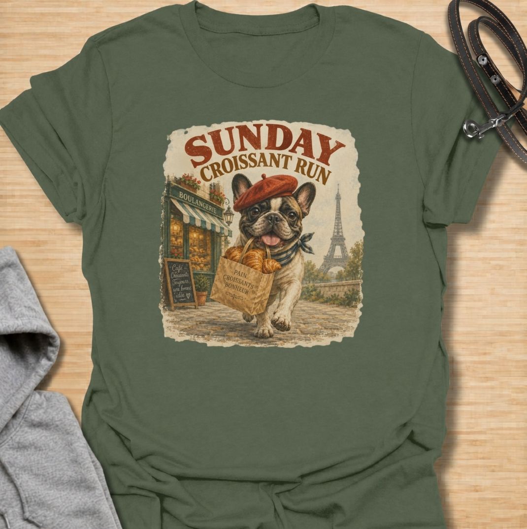 A fun French Bulldog T-shirt for anyone who loves Frenchies, coffee shop charm, and a little Paris-inspired humor. Featuring the phrase “Sunday Croissant Run” with a French Bulldog carrying a bakery bag, this design has a playful vintage travel-poster feel. Perfect for Frenchie moms, Frenchie dads, brunch lovers, bakery fans, and anyone who likes their dog shirts with a quirky lifestyle twist. A charming everyday tee for fans of French Bulldog art, French-inspired designs, and breed-specific gifts.