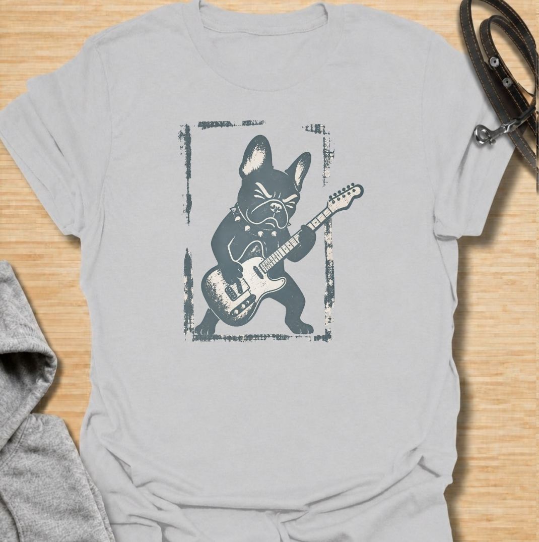 A fun French Bulldog T-shirt for anyone who knows their Frenchie has serious attitude and main-stage energy. Featuring a bold French Bulldog playing electric guitar, this graphic gives the breed a playful rock-and-roll twist without needing a slogan. Perfect for Frenchie moms, Frenchie dads, music lovers, and anyone who likes quirky breed-specific dog shirts. A strong everyday tee for fans of French Bulldog humor, alternative dog art, and unique dog lover gifts.