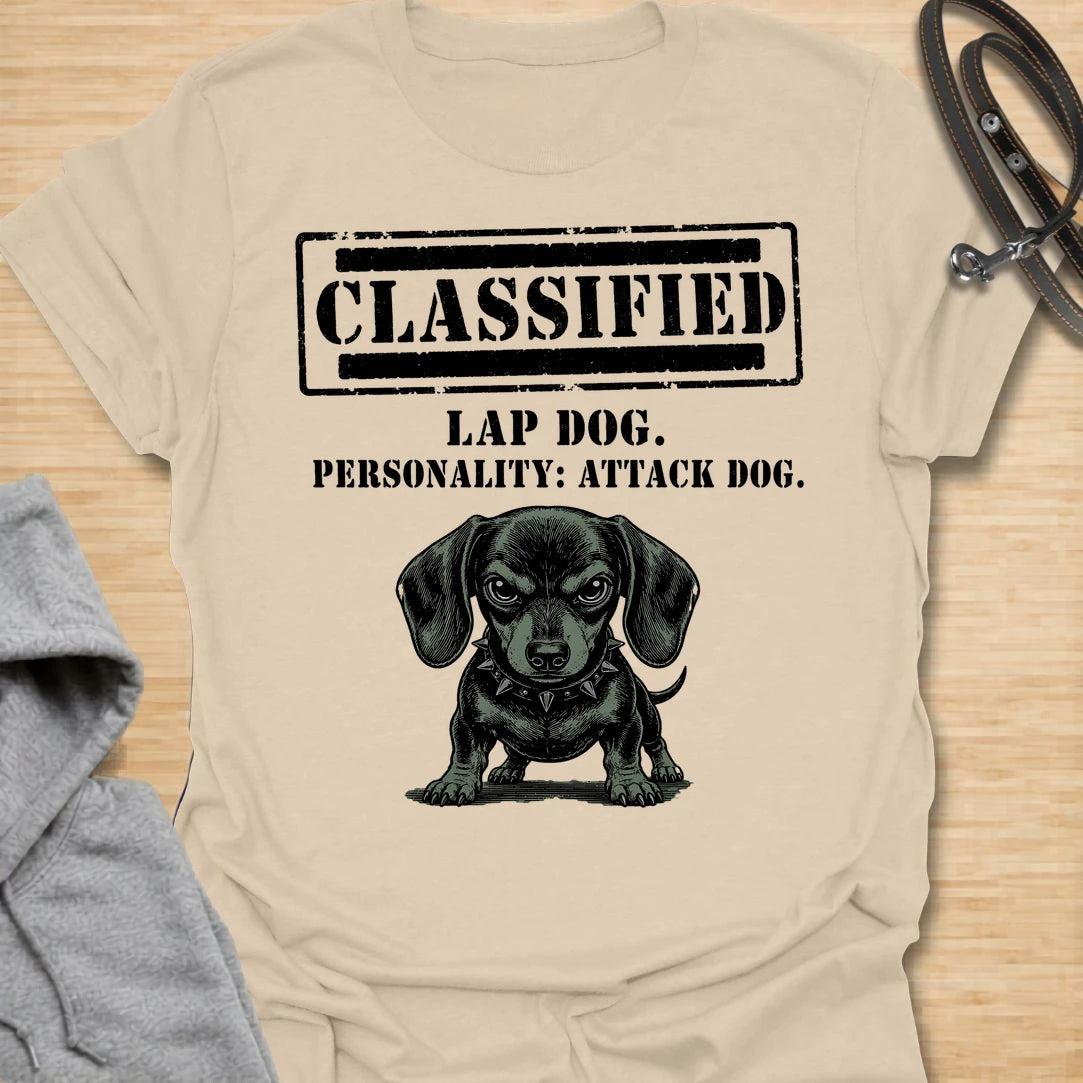 This Classified Lap Dog Personality Attack Dog t-shirt is made for dachshund lovers who know their tiny dog has serious main-character energy. Featuring a classified stamp-style layout, bold text, and a fierce little dachshund illustration, this design has a funny breed-specific attitude that doxie owners will instantly understand. Perfect for dachshund moms, dachshund dads, wiener dog fans, rescue dog lovers, and anyone whose lap dog acts like personal security.