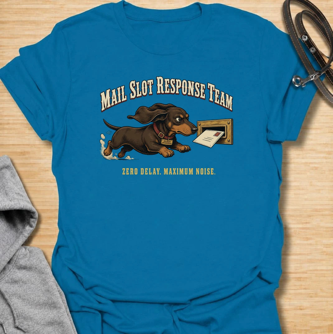 Zero delay and maximum noise. A funny dachshund T-shirt for sausage dogs who respond to every letter like a household emergency.