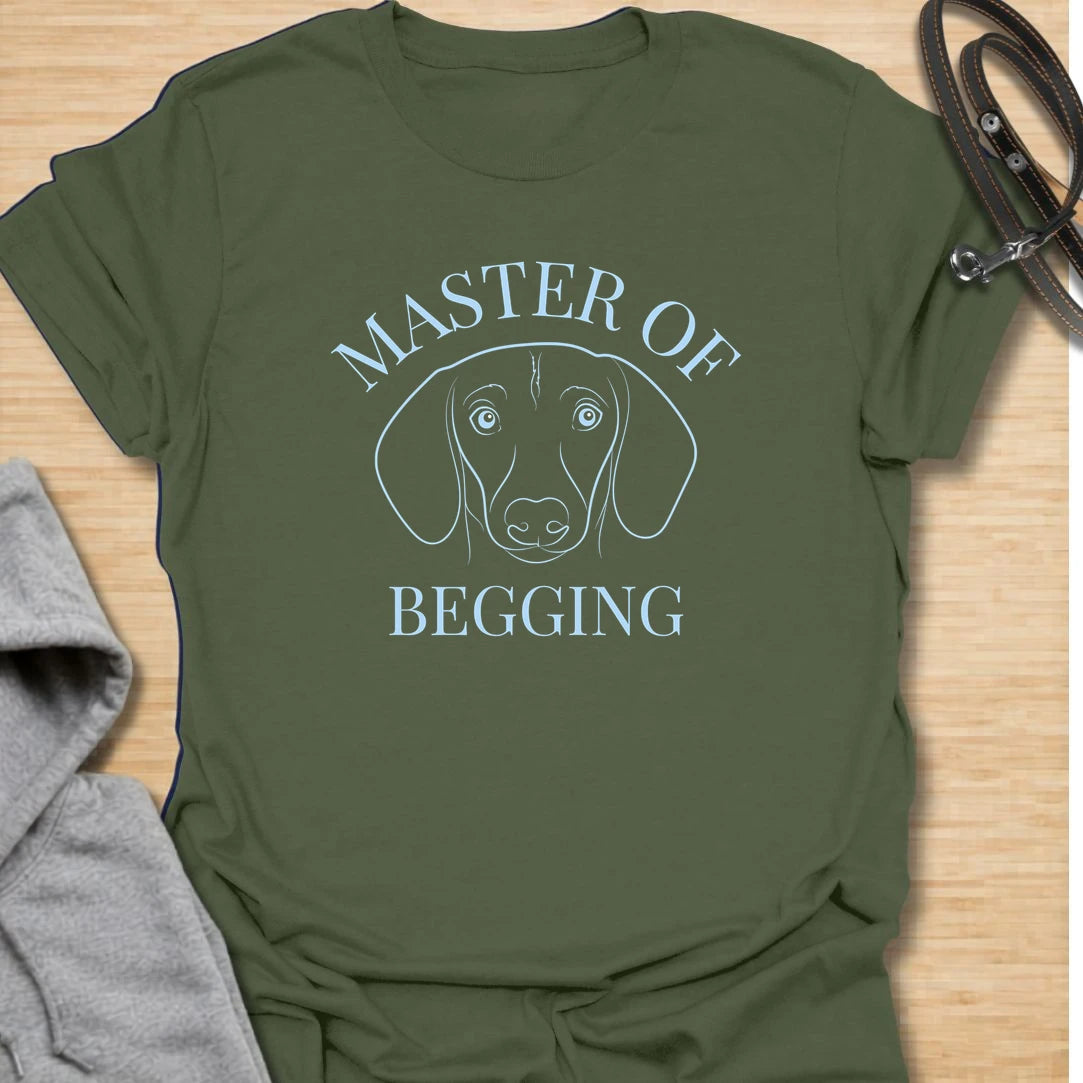 Master Of Begging t-shirt for dachshund owners who know those big doxie eyes are impossible to resist. This simple line-art dachshund design is perfect for sausage dog lovers, dog moms, and anyone whose pup has perfected the art of asking for treats. A funny gift for pet parents who live with a professional snack negotiator.