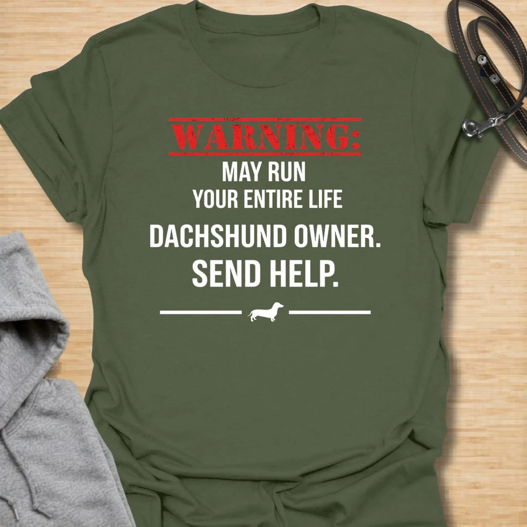 This Warning May Run Your Entire Life t-shirt is made for dachshund lovers who know their little long dog has completely taken over. Featuring bold warning-style typography, a small dachshund silhouette, and the phrase Dachshund Owner. Send Help., this design has a funny dog-parent feel that doxie owners will instantly understand. Perfect for dachshund moms, dachshund dads, wiener dog fans, rescue dog lovers, and anyone whose dachshund is absolutely in charge.