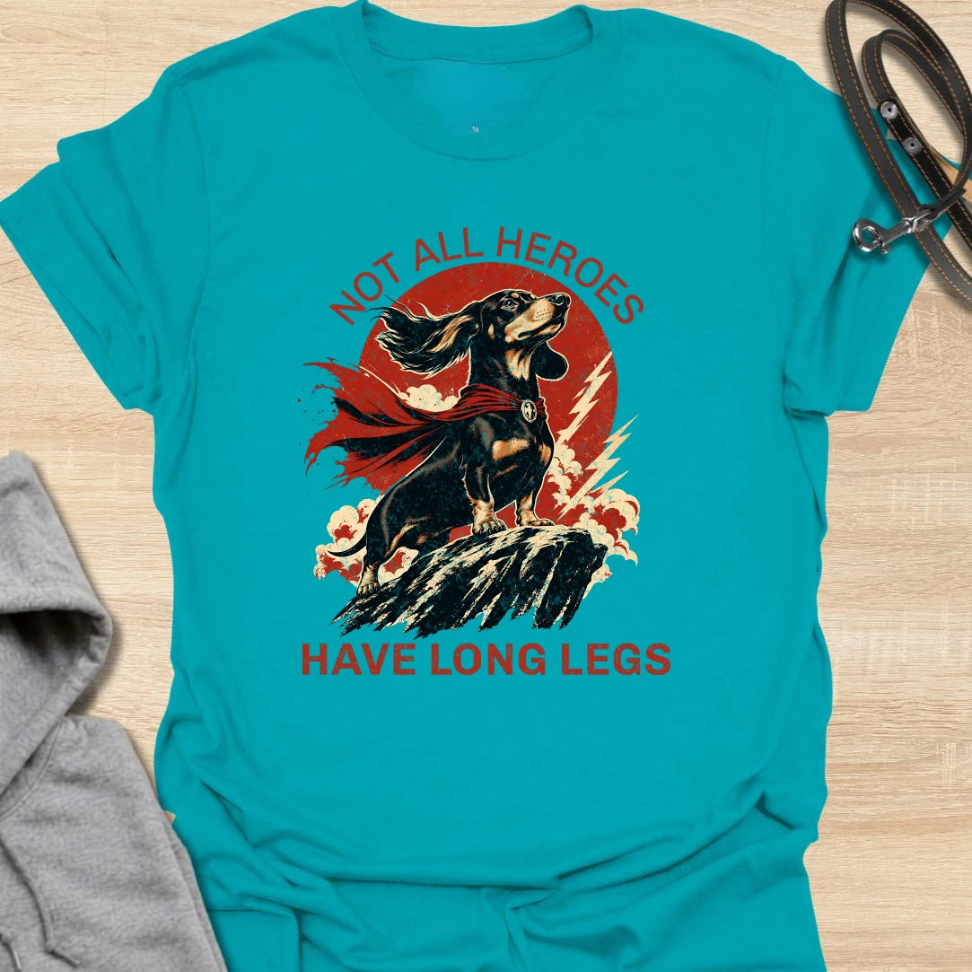 Not All Heroes Have Long Legs dachshund t-shirt for anyone who knows a sausage dog can still save the day. This bold comic-style design features a heroic dachshund with dramatic movement and strong vintage lettering. It is a fun gift for dachshund owners, doxie lovers, and wiener dog fans. Perfect for people who believe tiny legs can still carry a lot of personality.
