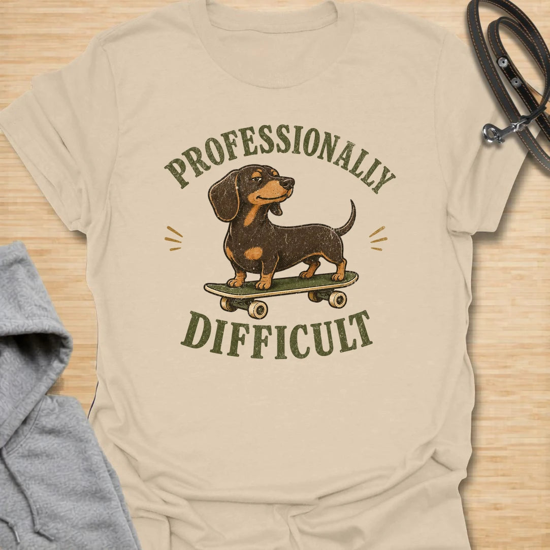 This Professionally Difficult t-shirt is made for dachshund lovers who know their little long dog has turned stubbornness into an art form. Featuring a smug dachshund standing on a skateboard with bold vintage-style lettering, this design has a funny breed-specific attitude. Perfect for dachshund moms, dachshund dads, wiener dog fans, rescue dog lovers, and anyone whose doxie is adorable but absolutely not easy.