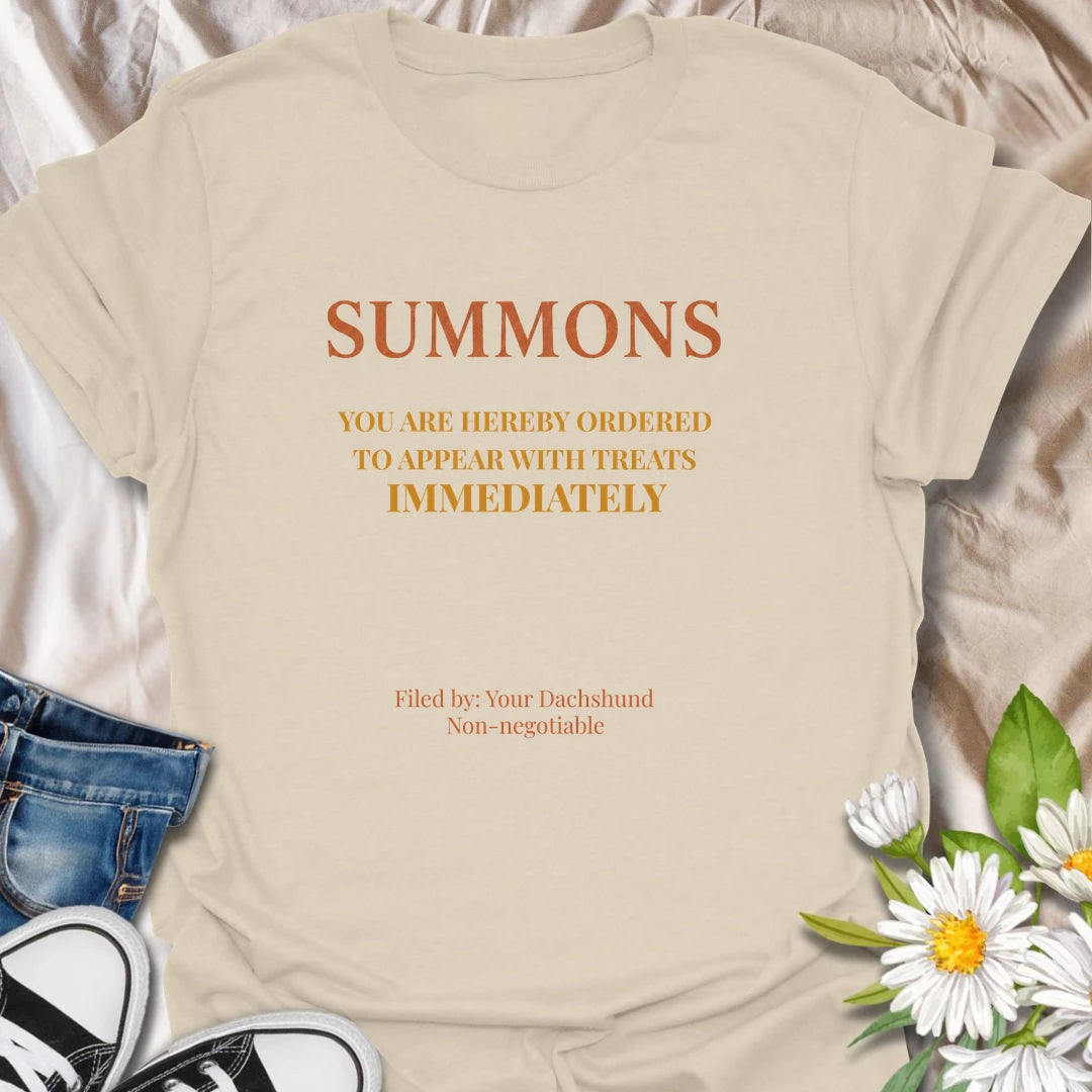 You have been officially ordered to appear with treats immediately, and your dachshund will accept no excuses. This funny legal-style dog T-shirt is made for owners familiar with non-negotiable snack demands. A clever gift for dachshund moms, dads, and anyone serving a tiny four-legged authority figure.