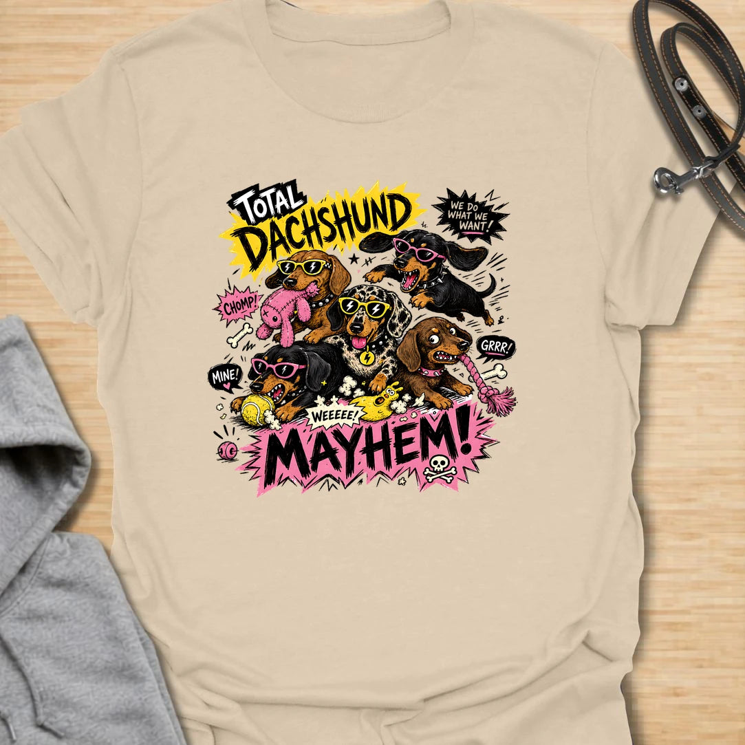 Dachshund Mayhem t-shirt for doxie lovers who live with tiny chaos, loud opinions, and nonstop sausage dog energy. This bold comic-style design features a wild pack of dachshunds causing total mayhem with toys, sunglasses, and attitude. Perfect for dachshund moms, multi-dog homes, and anyone who loves loud, funny dog designs.