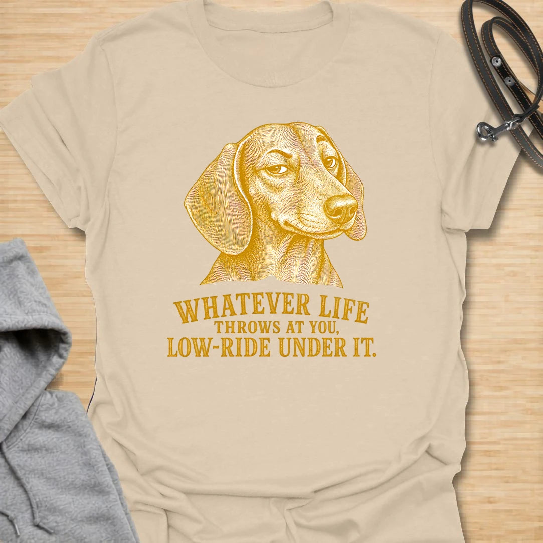 This Whatever Life Throws At You Low-Ride Under It t-shirt is made for dachshund lovers who know short legs can be a whole advantage. Featuring a vintage-style dachshund portrait and bold lettering, this design has a funny, resilient dog-parent feel. Perfect for dachshund moms, dachshund dads, wiener dog fans, rescue dog lovers, and anyone who loves a low-riding dog with a big personality.