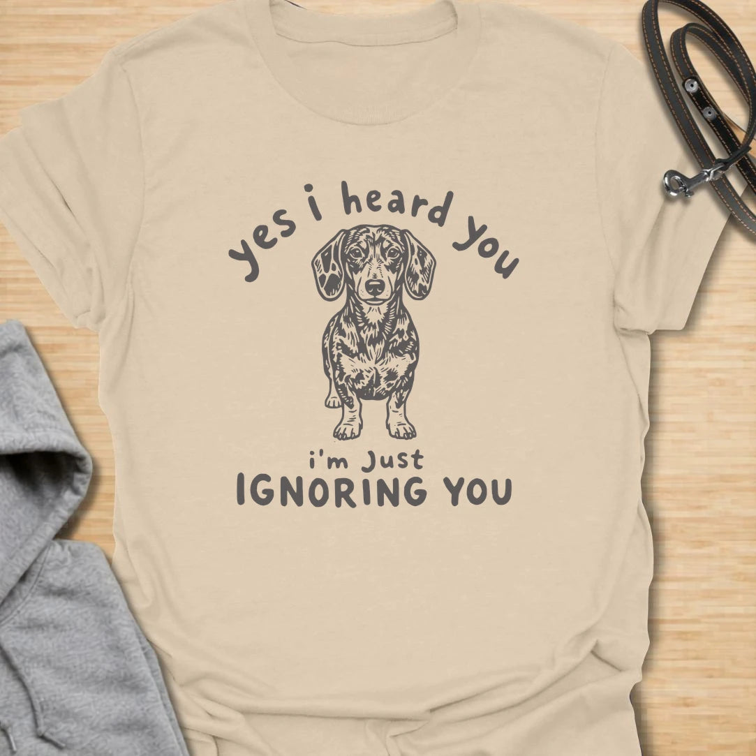 Ignoring You t-shirt for dachshund owners who know their dog hears everything but chooses selective listening. This funny design features a serious doxie with the phrase “Yes I Heard You I’m Just Ignoring You.” Perfect for sausage dog fans, doxie moms, and anyone living with a stubborn little dog.