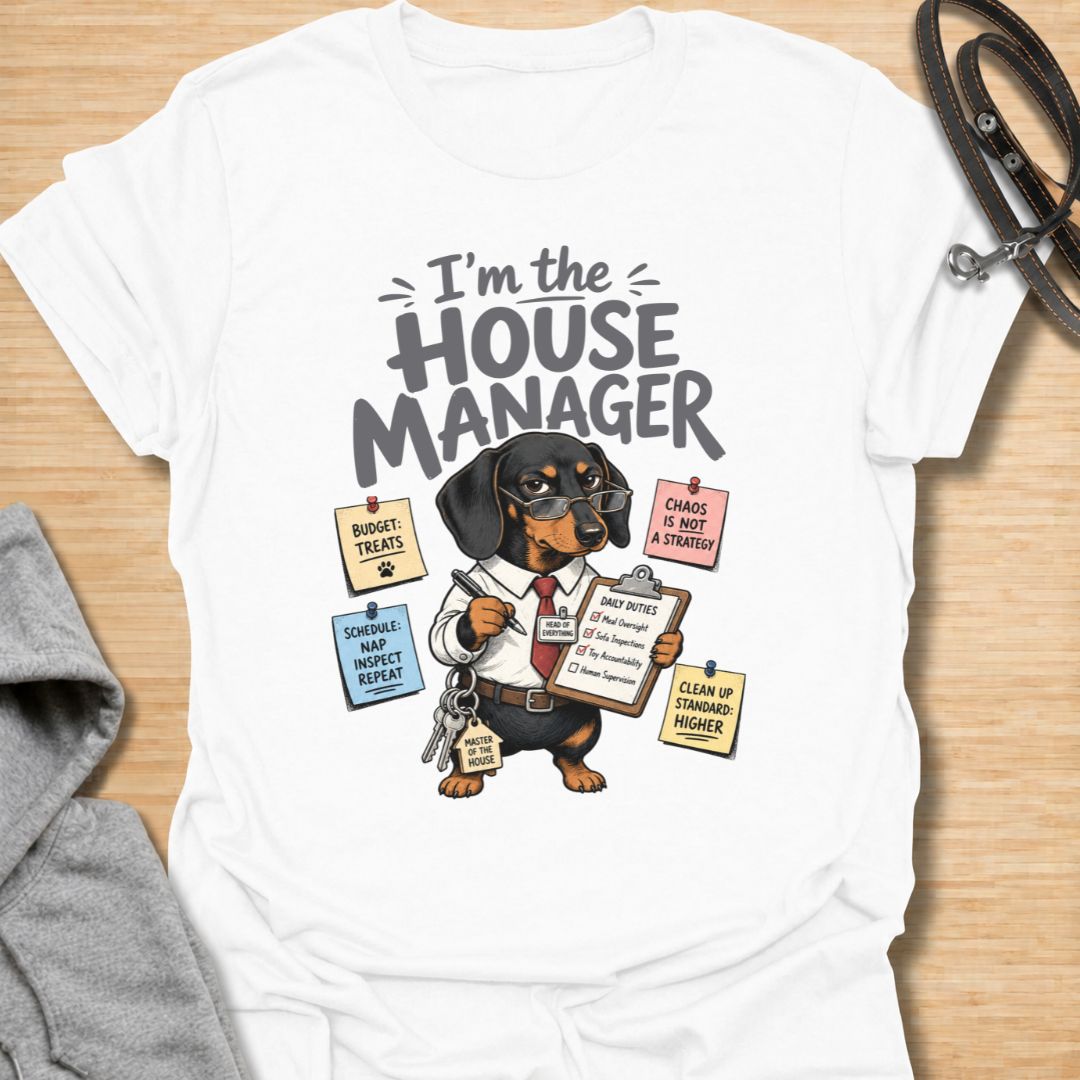 Celebrate life with a bossy little sausage dog in this funny “I’m the House Manager” dachshund T-shirt. Featuring a determined doxie managing treats, naps, household duties, and general chaos, it is perfect for dachshund moms, dog dads, and wiener dog lovers. A playful gift for anyone whose dachshund clearly runs the home.
