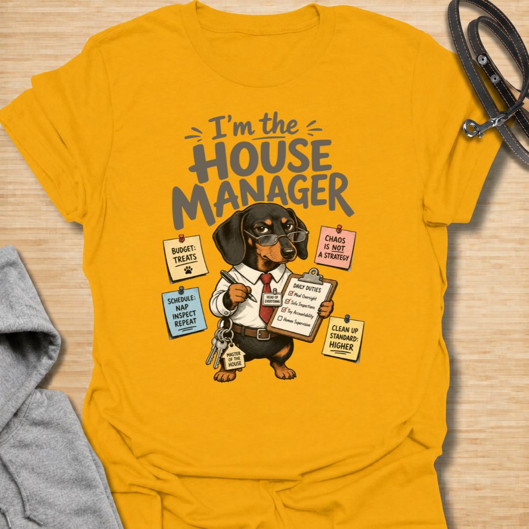 Celebrate life with a bossy little sausage dog in this funny “I’m the House Manager” dachshund T-shirt. Featuring a determined doxie managing treats, naps, household duties, and general chaos, it is perfect for dachshund moms, dog dads, and wiener dog lovers. A playful gift for anyone whose dachshund clearly runs the home.