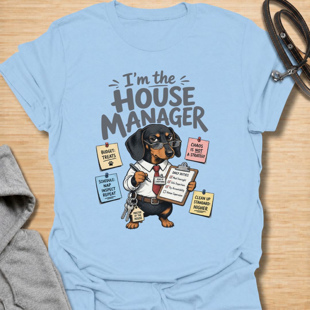 Celebrate life with a bossy little sausage dog in this funny “I’m the House Manager” dachshund T-shirt. Featuring a determined doxie managing treats, naps, household duties, and general chaos, it is perfect for dachshund moms, dog dads, and wiener dog lovers. A playful gift for anyone whose dachshund clearly runs the home.