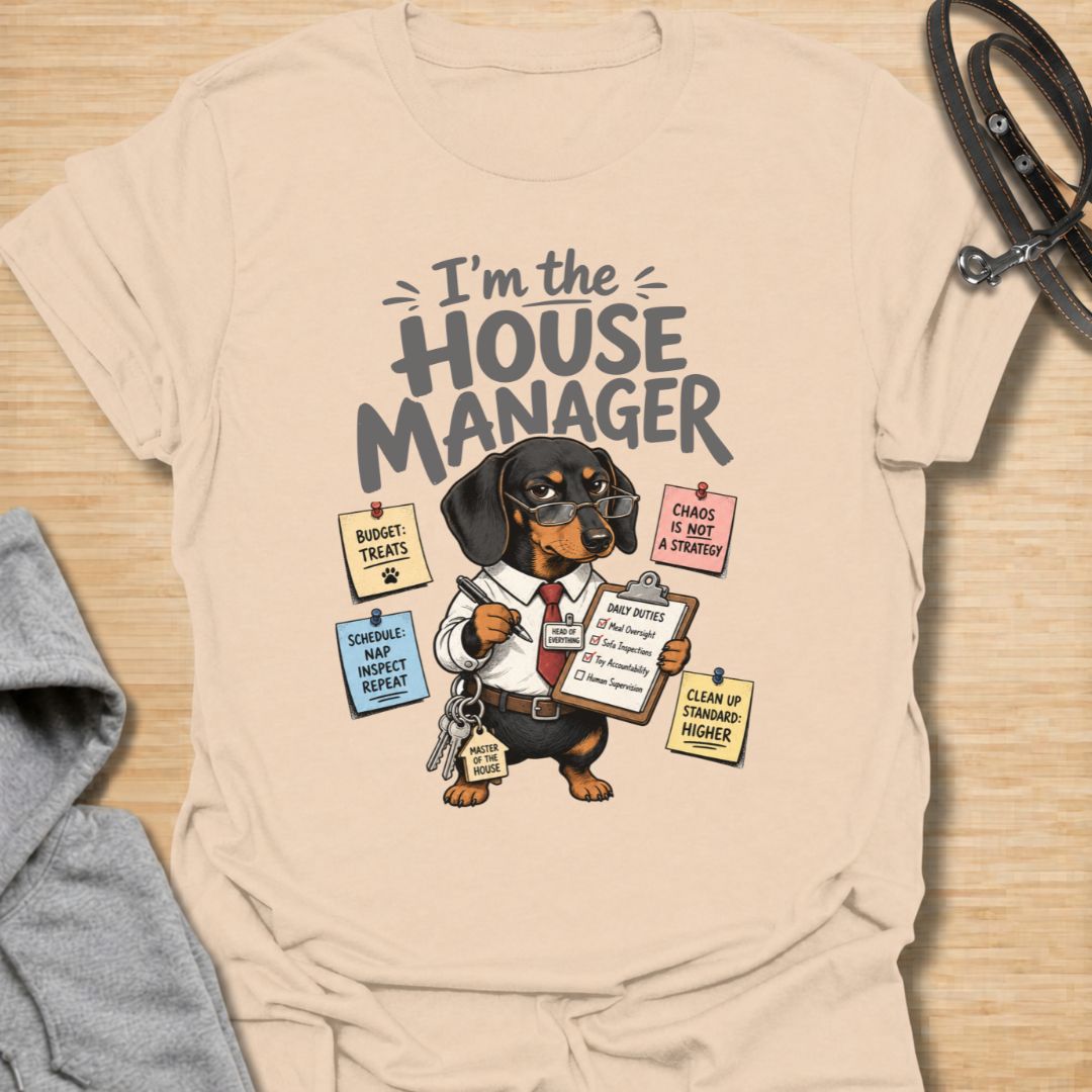 Celebrate life with a bossy little sausage dog in this funny “I’m the House Manager” dachshund T-shirt. Featuring a determined doxie managing treats, naps, household duties, and general chaos, it is perfect for dachshund moms, dog dads, and wiener dog lovers. A playful gift for anyone whose dachshund clearly runs the home.