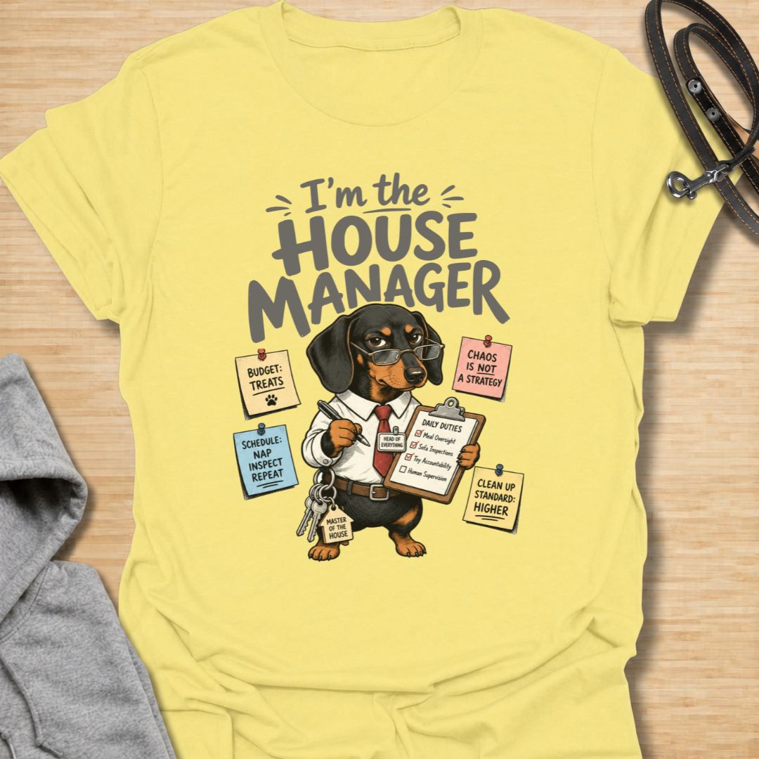 Celebrate life with a bossy little sausage dog in this funny “I’m the House Manager” dachshund T-shirt. Featuring a determined doxie managing treats, naps, household duties, and general chaos, it is perfect for dachshund moms, dog dads, and wiener dog lovers. A playful gift for anyone whose dachshund clearly runs the home.