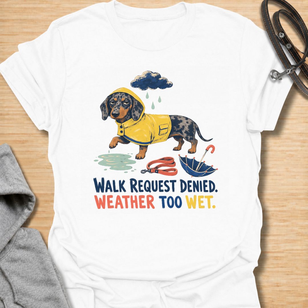 Celebrate a dachshund’s selective approach to outdoor adventures with this funny “Walk Request Denied, Weather Too Wet” T-shirt. Featuring a raincoat-wearing doxie beside a puddle, umbrella, and leash, it is perfect for dachshund moms, dog dads, and sausage dog lovers. A playful gift for anyone whose stubborn little dog refuses to walk in the rain.