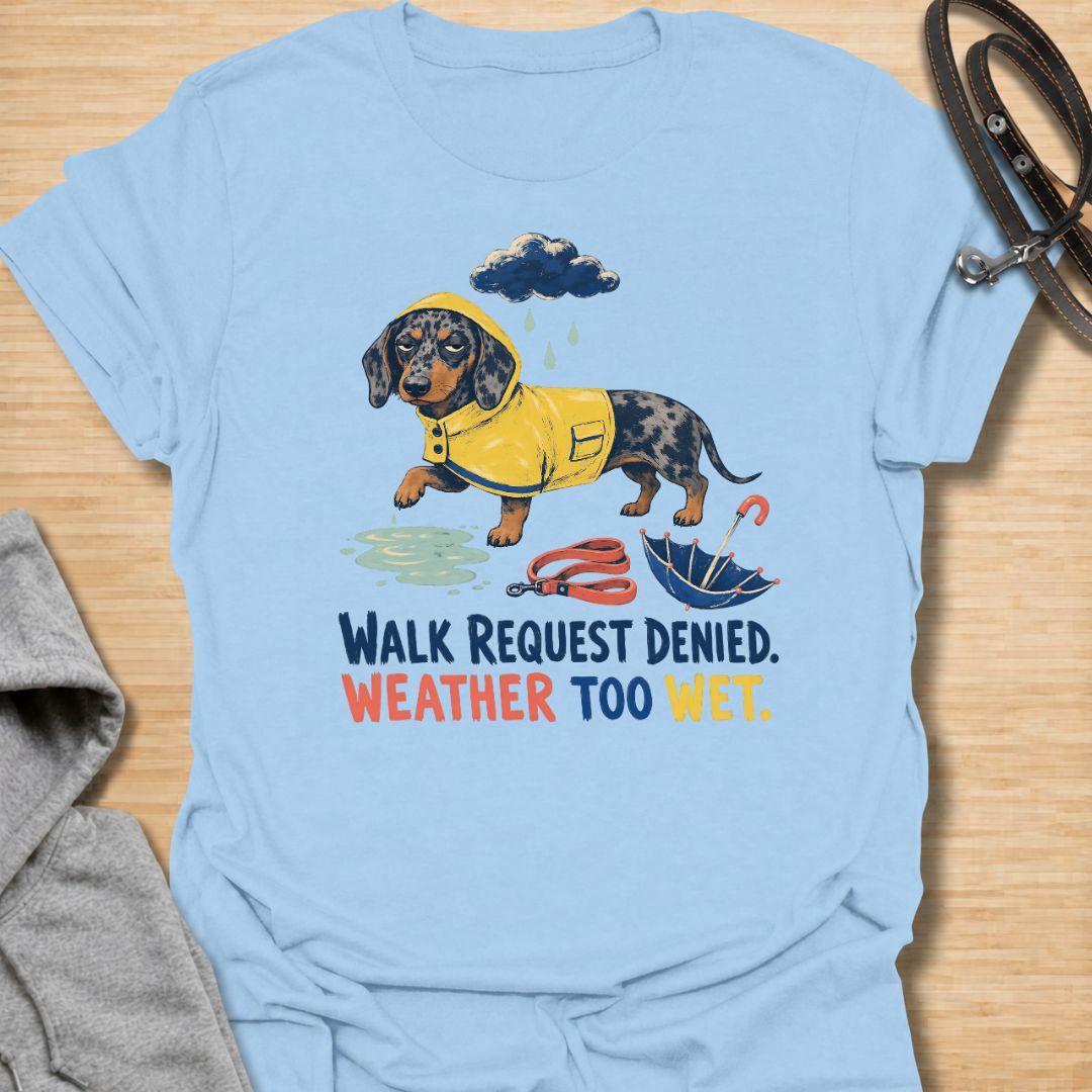 Celebrate a dachshund’s selective approach to outdoor adventures with this funny “Walk Request Denied, Weather Too Wet” T-shirt. Featuring a raincoat-wearing doxie beside a puddle, umbrella, and leash, it is perfect for dachshund moms, dog dads, and sausage dog lovers. A playful gift for anyone whose stubborn little dog refuses to walk in the rain.