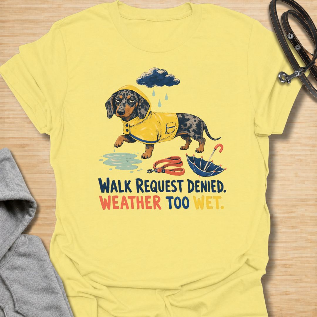 Celebrate a dachshund’s selective approach to outdoor adventures with this funny “Walk Request Denied, Weather Too Wet” T-shirt. Featuring a raincoat-wearing doxie beside a puddle, umbrella, and leash, it is perfect for dachshund moms, dog dads, and sausage dog lovers. A playful gift for anyone whose stubborn little dog refuses to walk in the rain.