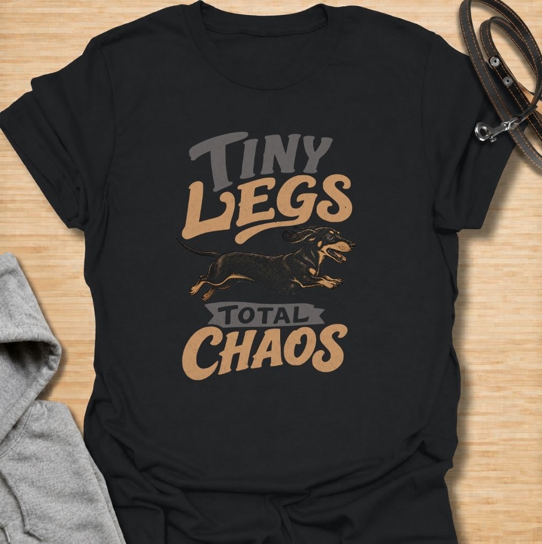 Tiny legs, total chaos. A funny dachshund T-shirt for sausage dog owners who know those short legs can create trouble at remarkable speed.