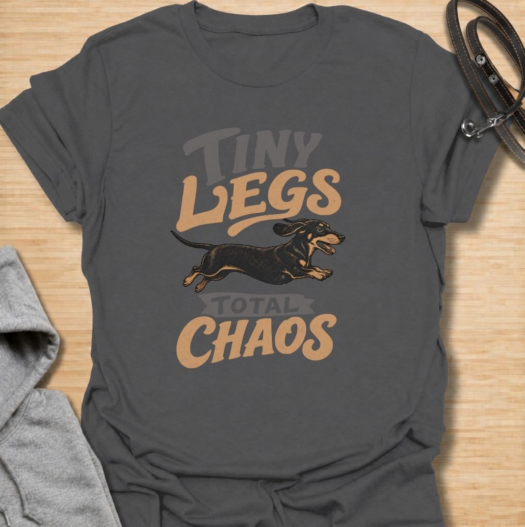 Tiny legs, total chaos. A funny dachshund T-shirt for sausage dog owners who know those short legs can create trouble at remarkable speed.