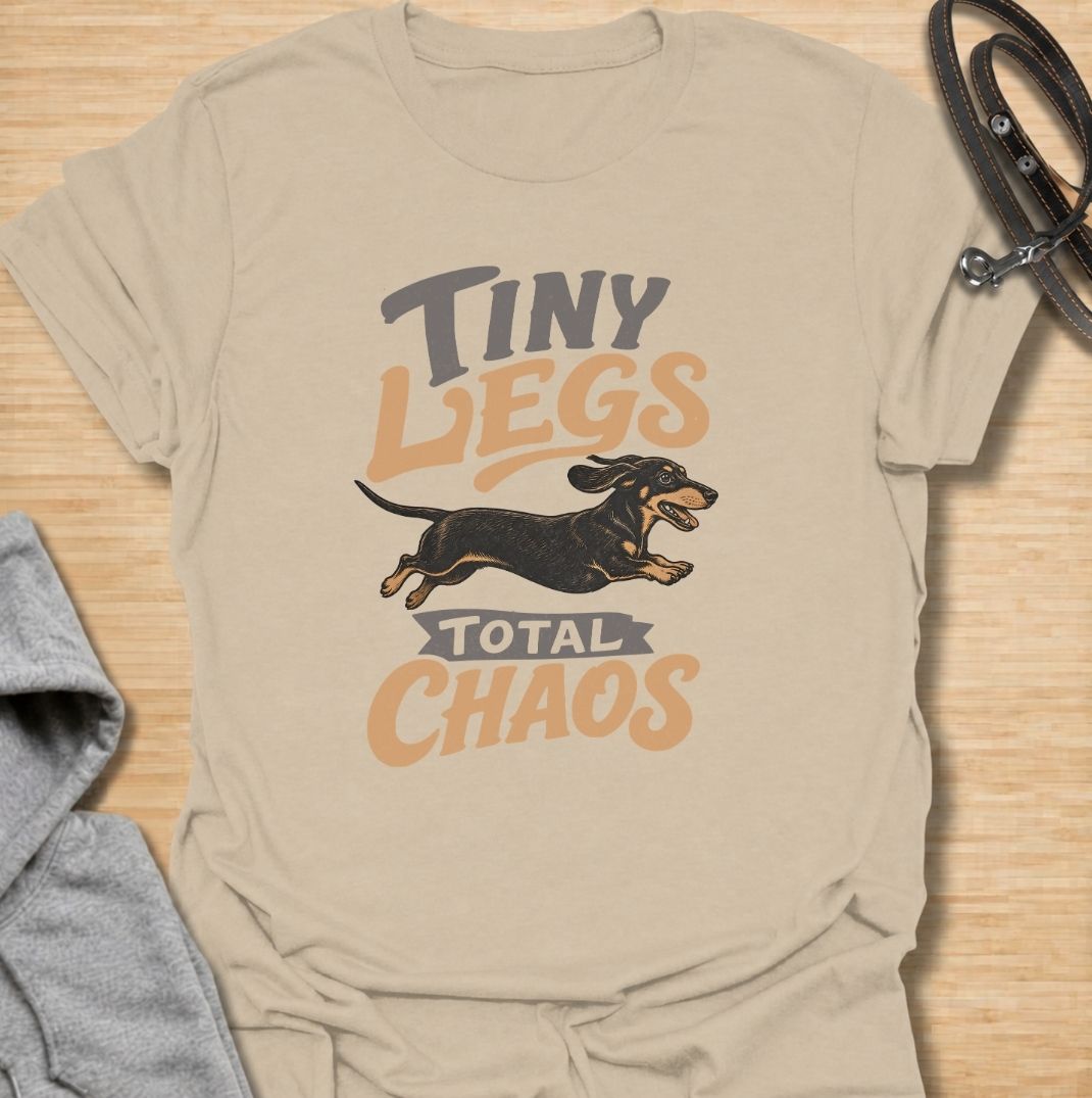 Tiny legs, total chaos. A funny dachshund T-shirt for sausage dog owners who know those short legs can create trouble at remarkable speed.