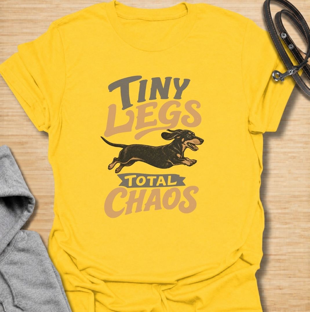 Tiny legs, total chaos. A funny dachshund T-shirt for sausage dog owners who know those short legs can create trouble at remarkable speed.