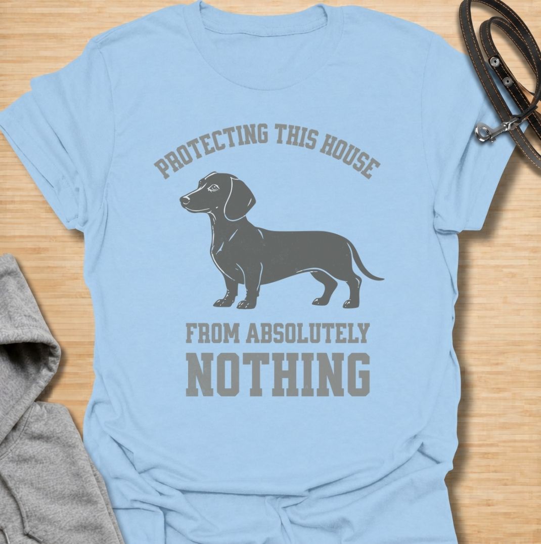 Protecting this house from absolutely nothing. A funny dachshund T-shirt for sausage dog owners who know their little watchdog takes security very seriously.