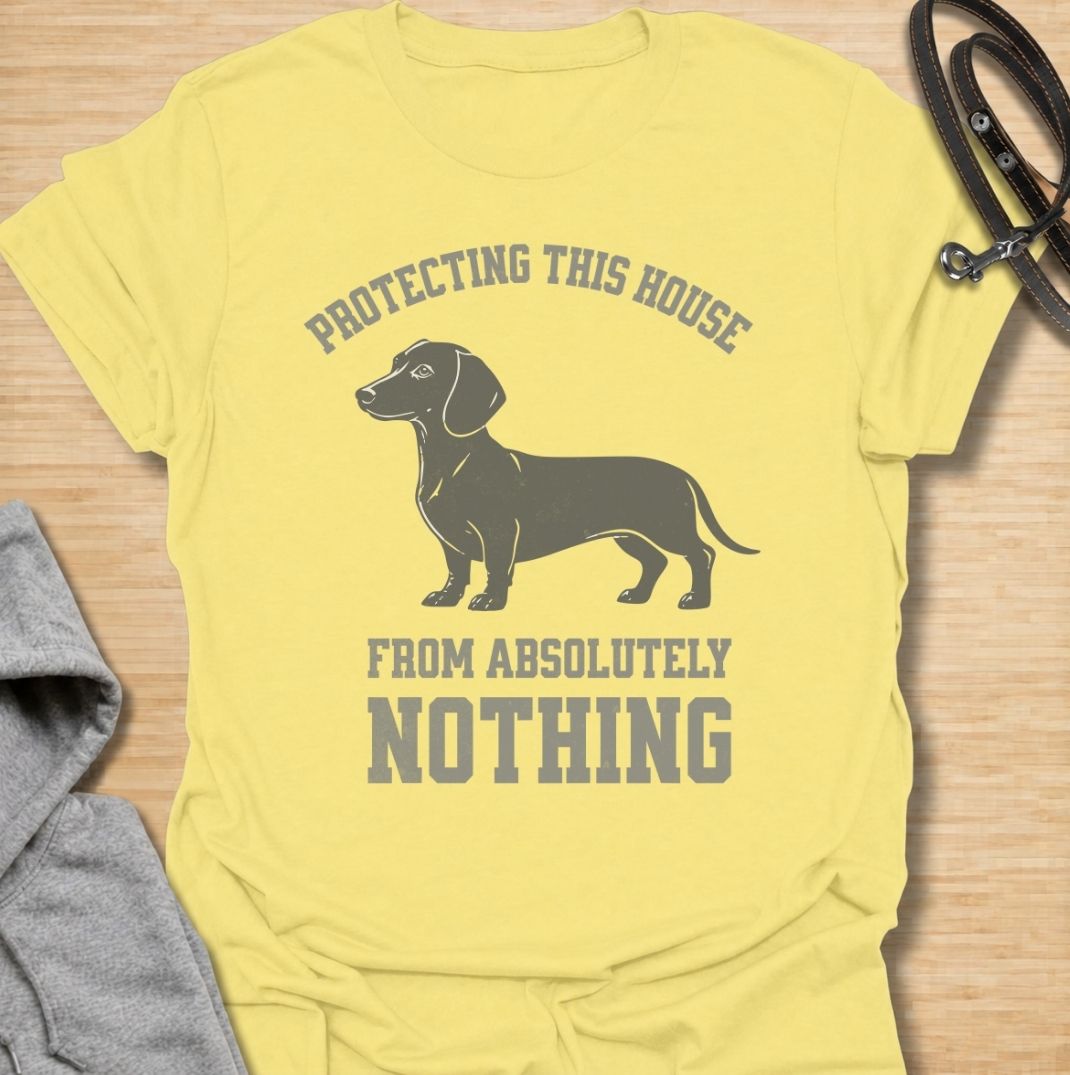 Protecting this house from absolutely nothing. A funny dachshund T-shirt for sausage dog owners who know their little watchdog takes security very seriously.