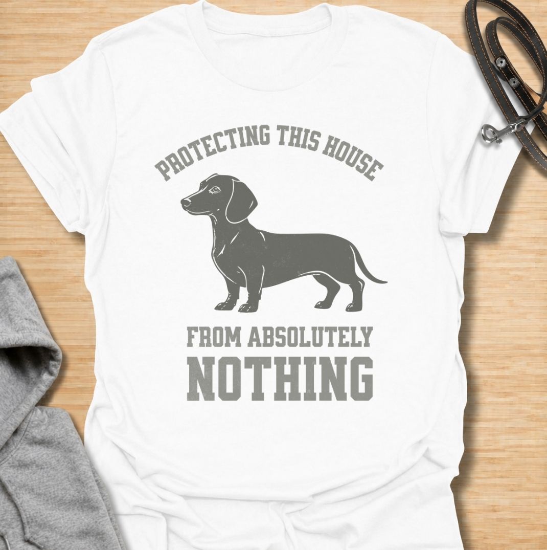 Protecting this house from absolutely nothing. A funny dachshund T-shirt for sausage dog owners who know their little watchdog takes security very seriously.