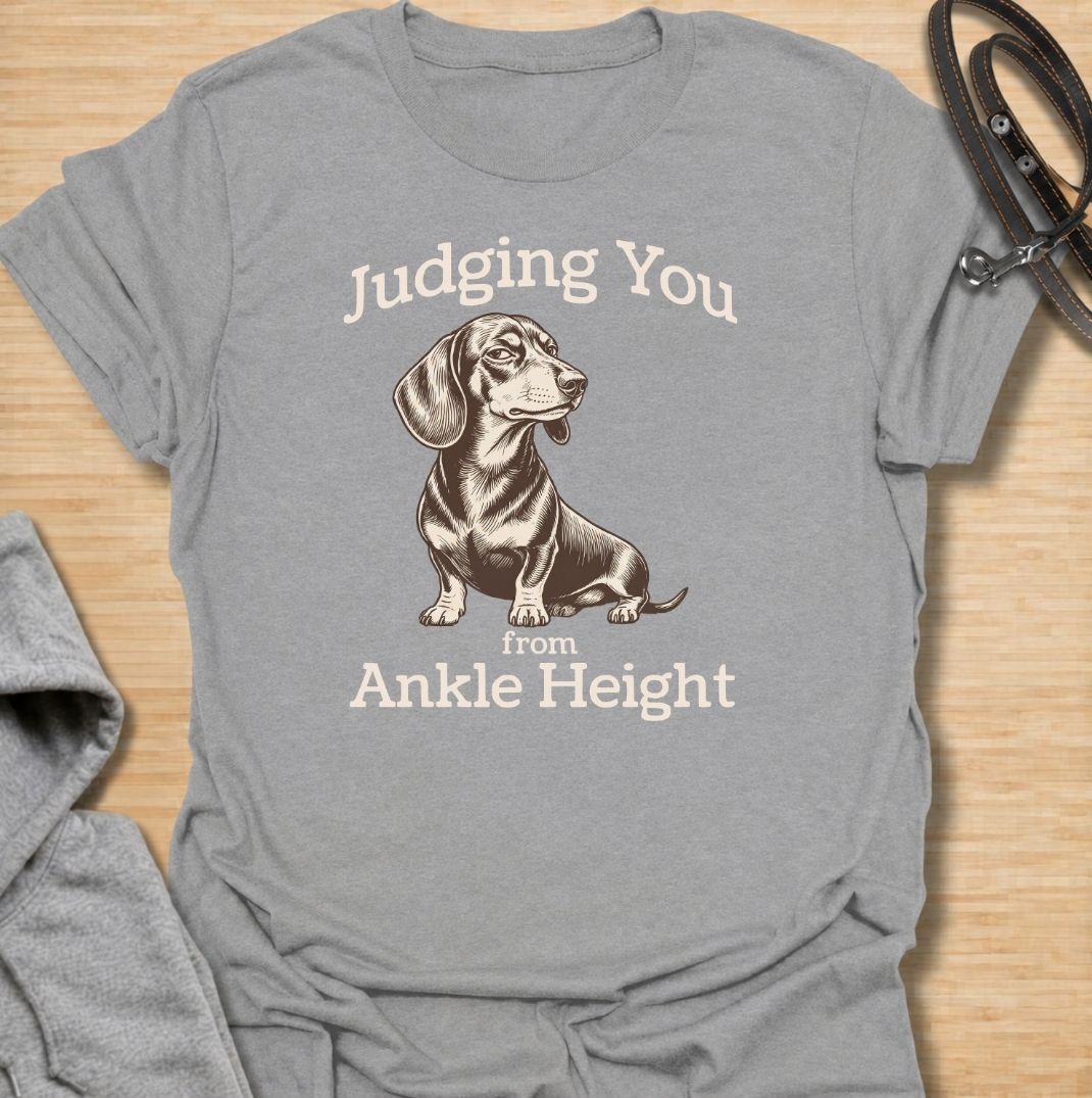 Judging you from ankle height. A funny dachshund T-shirt for sausage dog owners who know those short legs come with very big opinions.