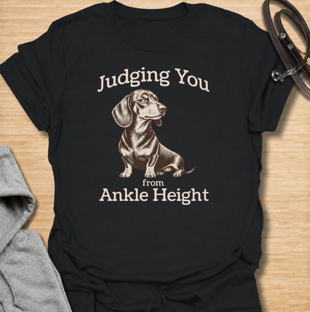 Judging you from ankle height. A funny dachshund T-shirt for sausage dog owners who know those short legs come with very big opinions.