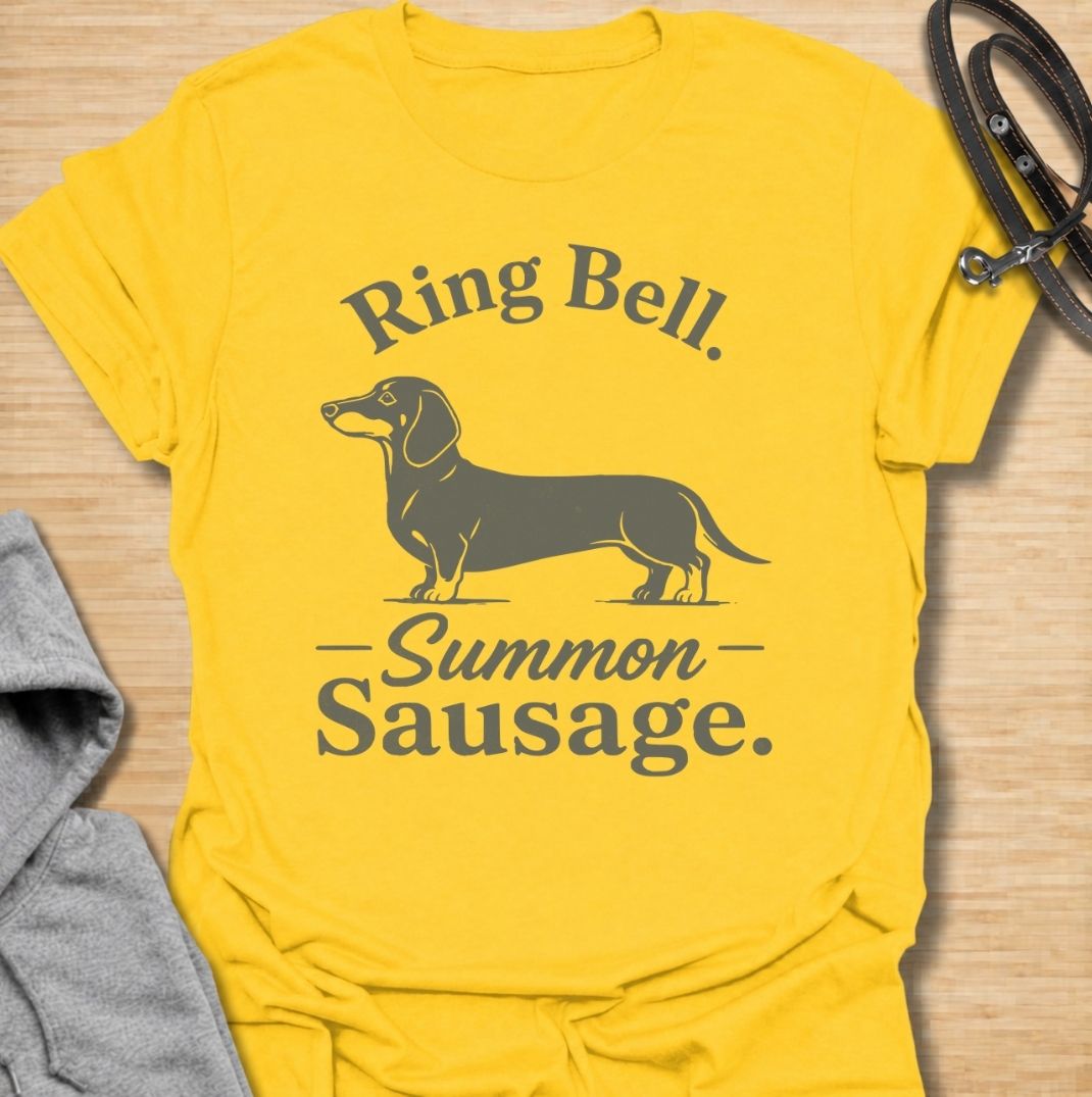 Ring bell, summon sausage. A funny dachshund T-shirt for sausage dog owners who know the doorbell instantly activates their little household alarm.