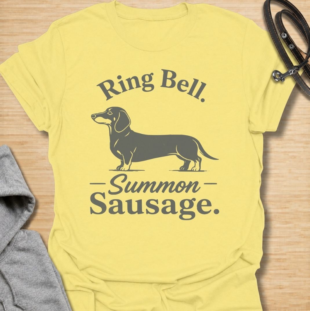 Ring bell, summon sausage. A funny dachshund T-shirt for sausage dog owners who know the doorbell instantly activates their little household alarm.