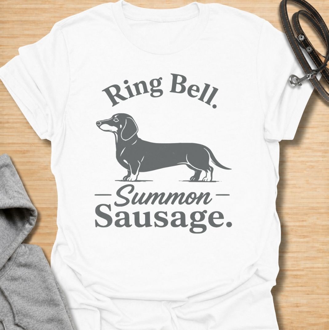 Ring bell, summon sausage. A funny dachshund T-shirt for sausage dog owners who know the doorbell instantly activates their little household alarm.