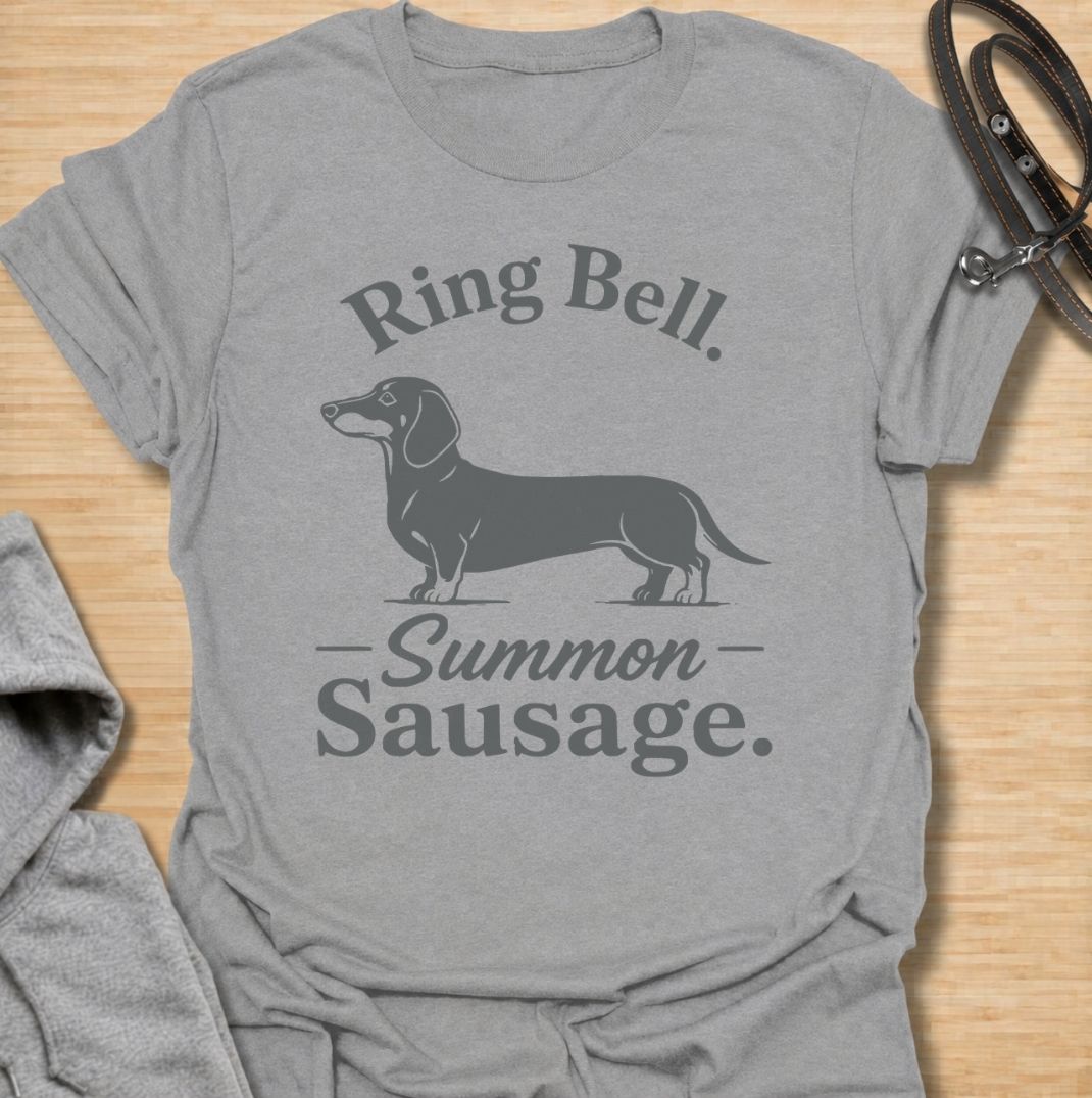 Ring bell, summon sausage. A funny dachshund T-shirt for sausage dog owners who know the doorbell instantly activates their little household alarm.