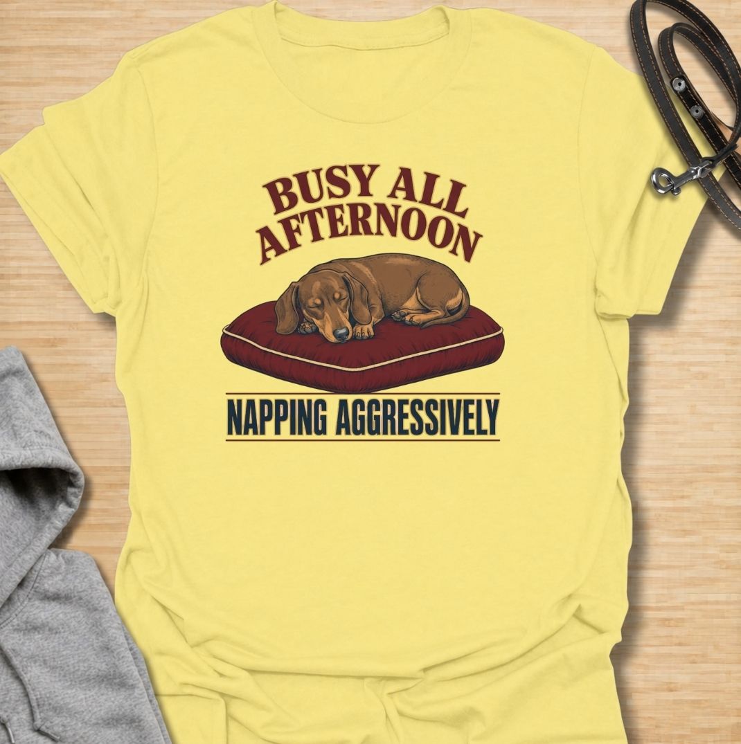 For dachshund owners who know that napping is serious business.
This funny dachshund T-shirt features a sleepy sausage dog with the phrase “Busy All Afternoon – Napping Aggressively.”
A great choice for dog lovers who appreciate lazy afternoons, dry humor, and classic dachshund attitude.
Perfect for everyday wear, weekends, lounging, or gifting to the dachshund-obsessed.
A fun dog lover tee with vintage-inspired style and plenty of personality.
