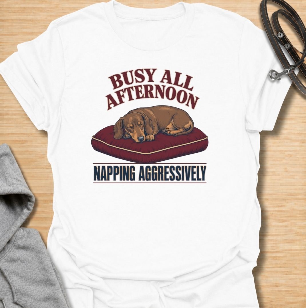 For dachshund owners who know that napping is serious business.
This funny dachshund T-shirt features a sleepy sausage dog with the phrase “Busy All Afternoon – Napping Aggressively.”
A great choice for dog lovers who appreciate lazy afternoons, dry humor, and classic dachshund attitude.
Perfect for everyday wear, weekends, lounging, or gifting to the dachshund-obsessed.
A fun dog lover tee with vintage-inspired style and plenty of personality.