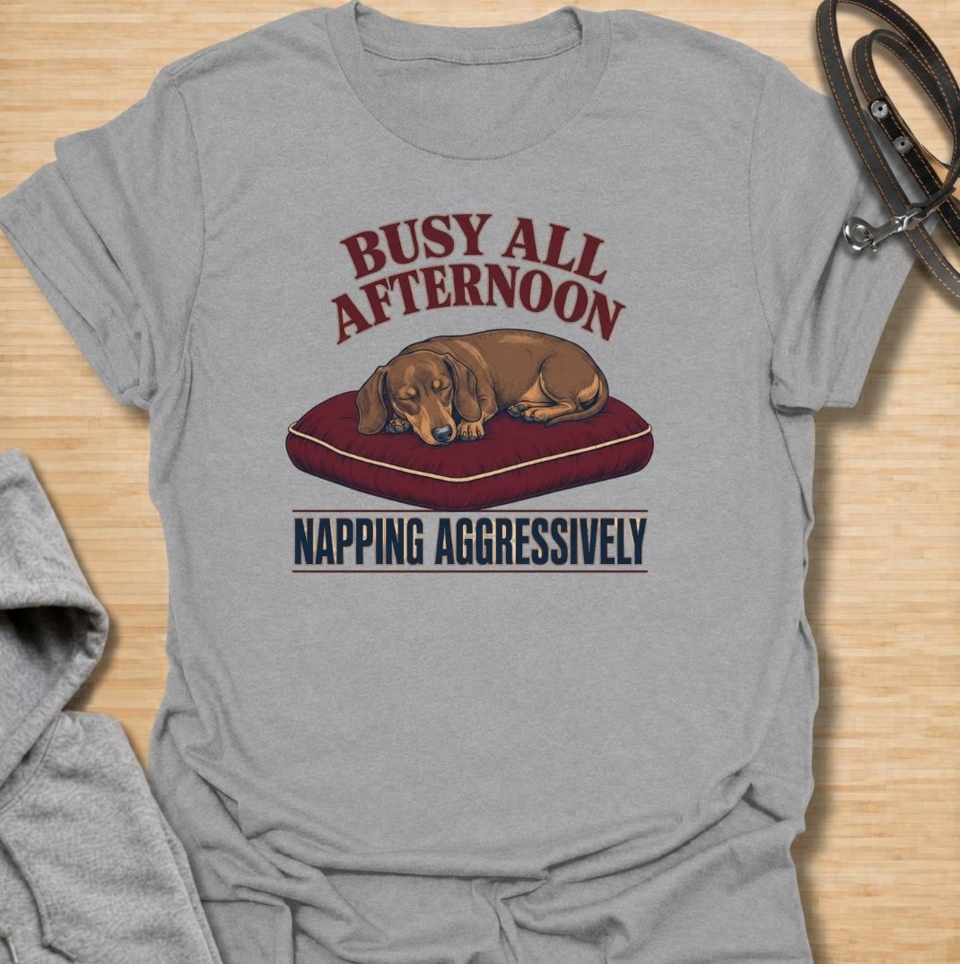 For dachshund owners who know that napping is serious business.
This funny dachshund T-shirt features a sleepy sausage dog with the phrase “Busy All Afternoon – Napping Aggressively.”
A great choice for dog lovers who appreciate lazy afternoons, dry humor, and classic dachshund attitude.
Perfect for everyday wear, weekends, lounging, or gifting to the dachshund-obsessed.
A fun dog lover tee with vintage-inspired style and plenty of personality.