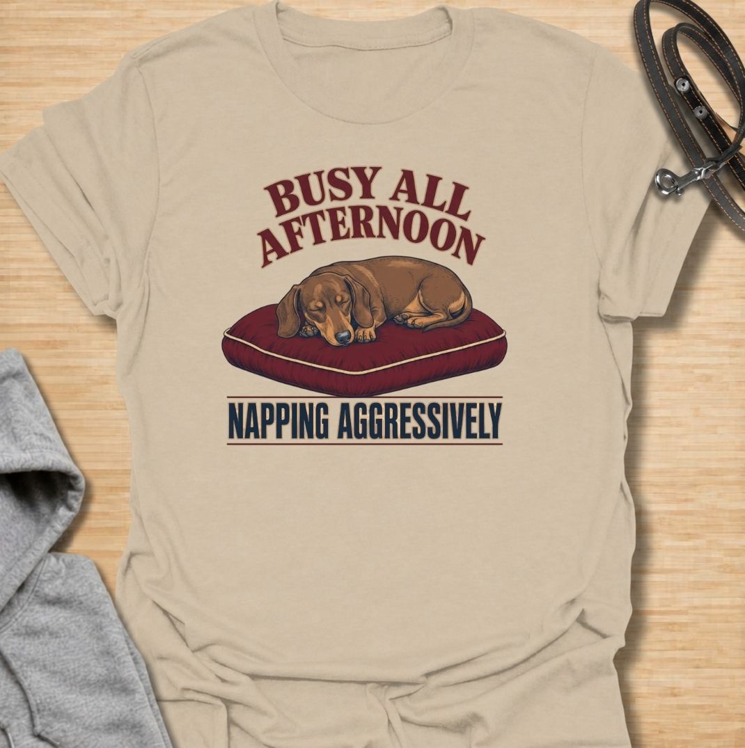 For dachshund owners who know that napping is serious business.
This funny dachshund T-shirt features a sleepy sausage dog with the phrase “Busy All Afternoon – Napping Aggressively.”
A great choice for dog lovers who appreciate lazy afternoons, dry humor, and classic dachshund attitude.
Perfect for everyday wear, weekends, lounging, or gifting to the dachshund-obsessed.
A fun dog lover tee with vintage-inspired style and plenty of personality.