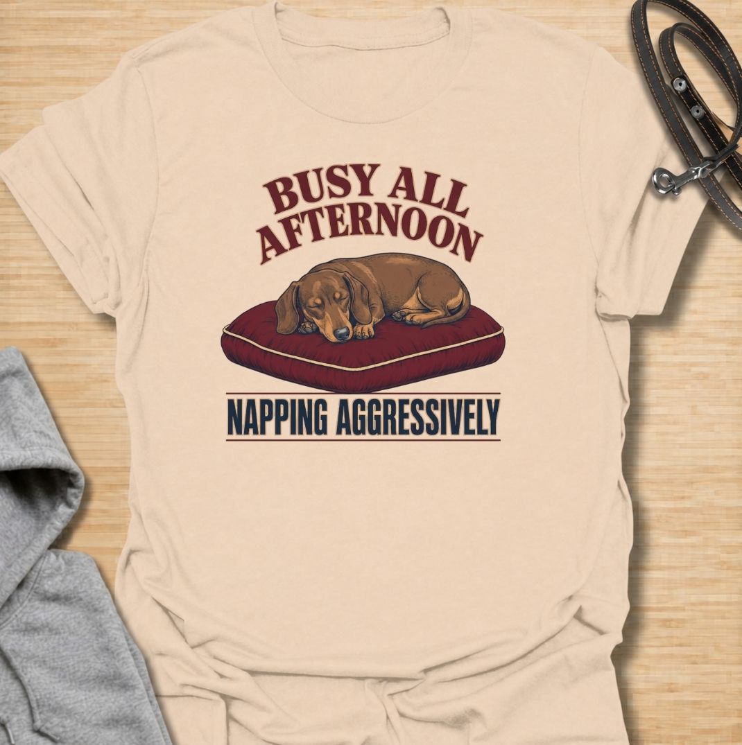 For dachshund owners who know that napping is serious business.
This funny dachshund T-shirt features a sleepy sausage dog with the phrase “Busy All Afternoon – Napping Aggressively.”
A great choice for dog lovers who appreciate lazy afternoons, dry humor, and classic dachshund attitude.
Perfect for everyday wear, weekends, lounging, or gifting to the dachshund-obsessed.
A fun dog lover tee with vintage-inspired style and plenty of personality.