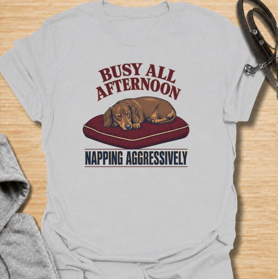 For dachshund owners who know that napping is serious business.
This funny dachshund T-shirt features a sleepy sausage dog with the phrase “Busy All Afternoon – Napping Aggressively.”
A great choice for dog lovers who appreciate lazy afternoons, dry humor, and classic dachshund attitude.
Perfect for everyday wear, weekends, lounging, or gifting to the dachshund-obsessed.
A fun dog lover tee with vintage-inspired style and plenty of personality.