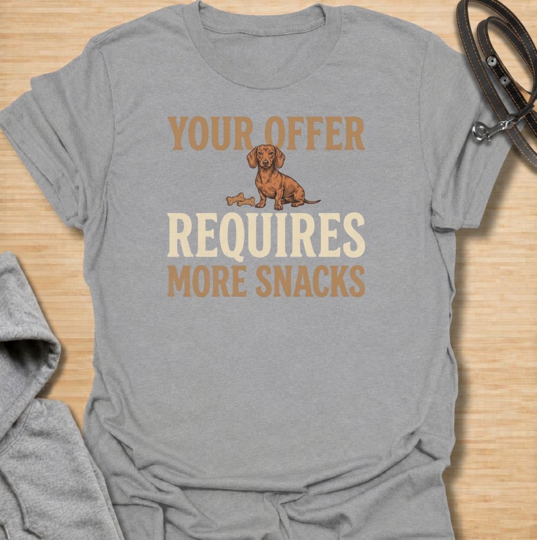 For dachshunds who know every offer can be improved with the addition of snacks. This funny dachshund T-shirt features the phrase “Your Offer Requires More Snacks” with a stubborn little doxie at the center. Perfect for dachshund owners who know treats are less of a reward and more of a bargaining tool. A playful dog lover tee packed with classic sausage dog attitude.