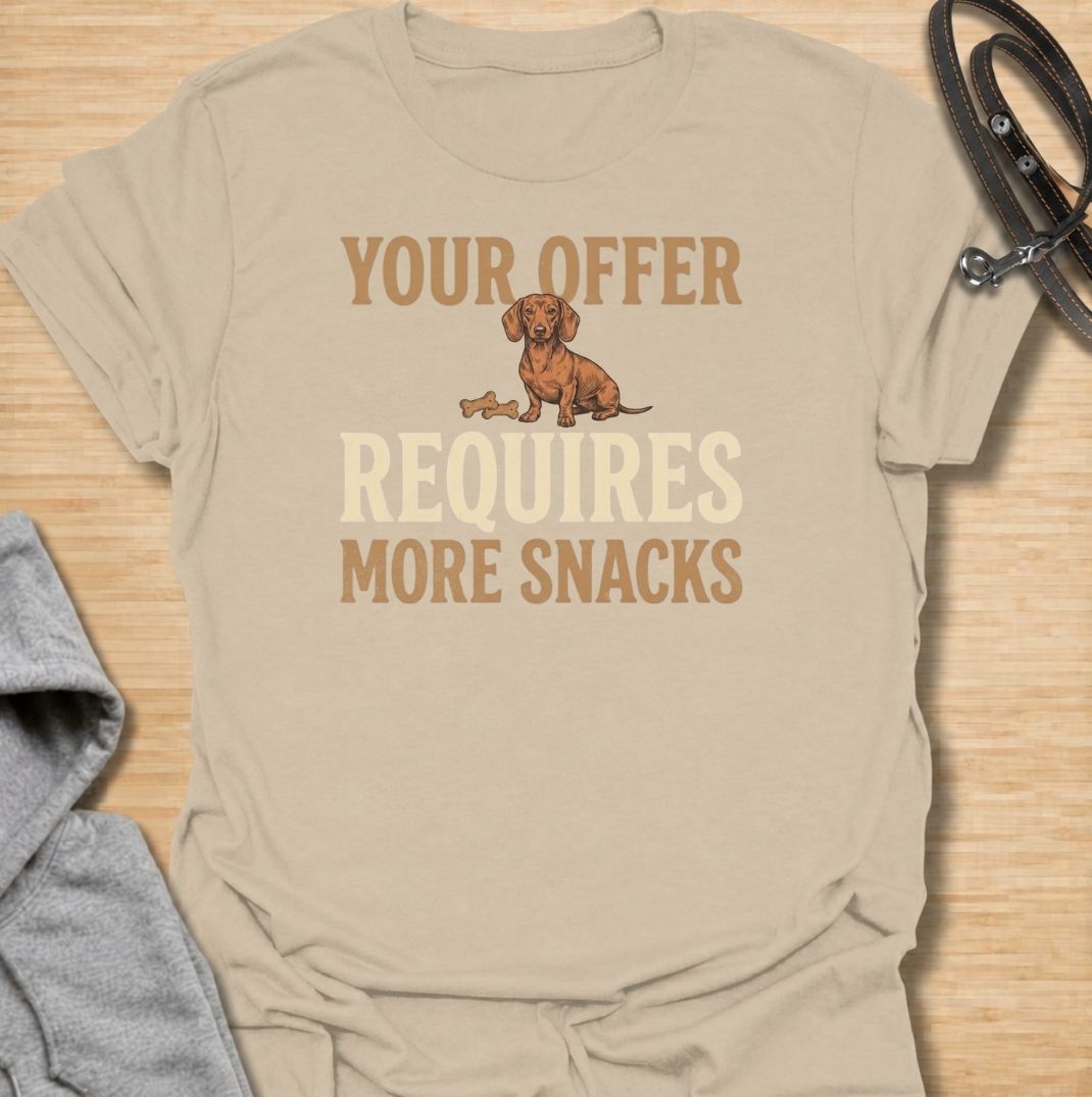 For dachshunds who know every offer can be improved with the addition of snacks. This funny dachshund T-shirt features the phrase “Your Offer Requires More Snacks” with a stubborn little doxie at the center. Perfect for dachshund owners who know treats are less of a reward and more of a bargaining tool. A playful dog lover tee packed with classic sausage dog attitude.