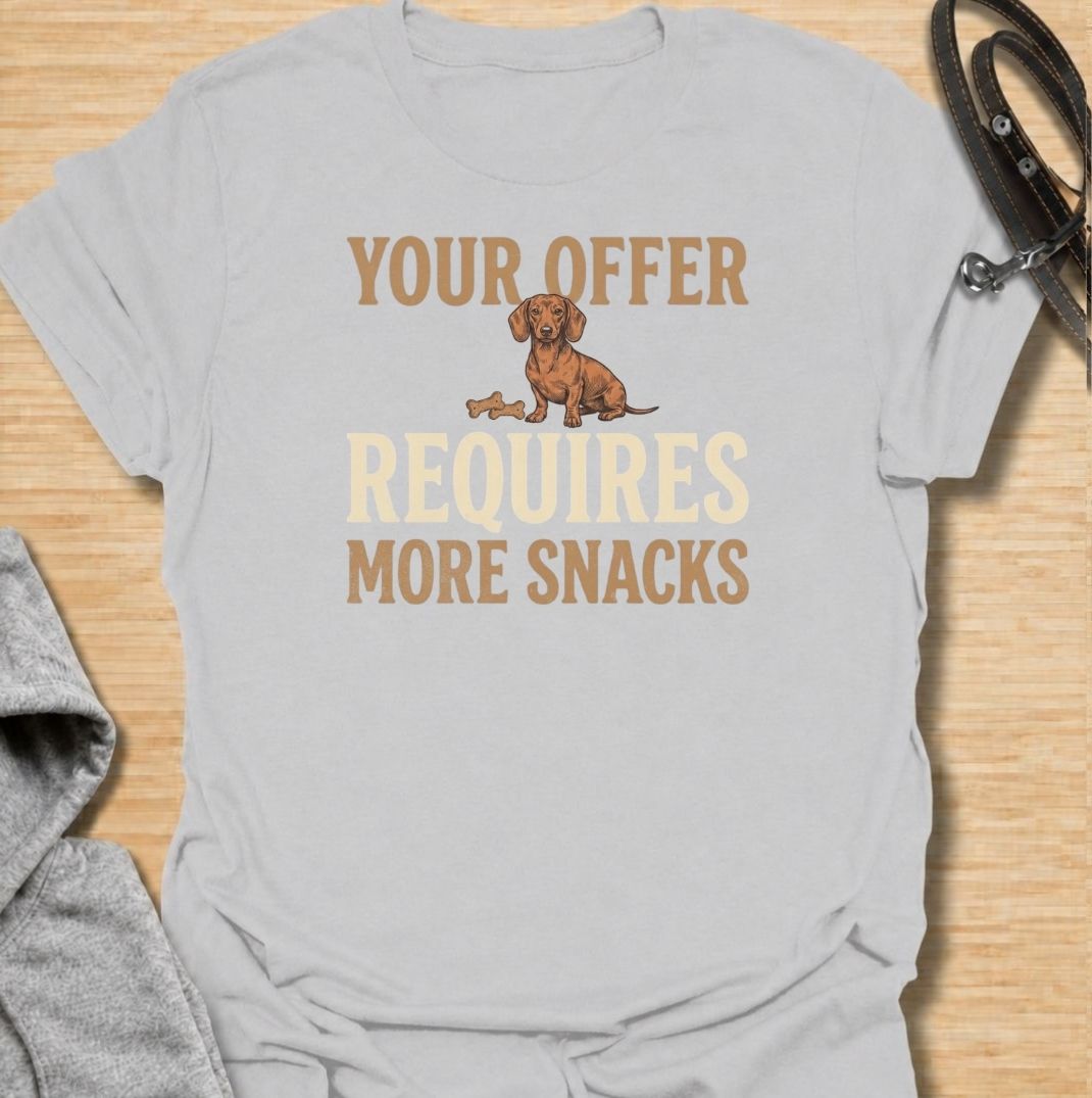 For dachshunds who know every offer can be improved with the addition of snacks. This funny dachshund T-shirt features the phrase “Your Offer Requires More Snacks” with a stubborn little doxie at the center. Perfect for dachshund owners who know treats are less of a reward and more of a bargaining tool. A playful dog lover tee packed with classic sausage dog attitude.