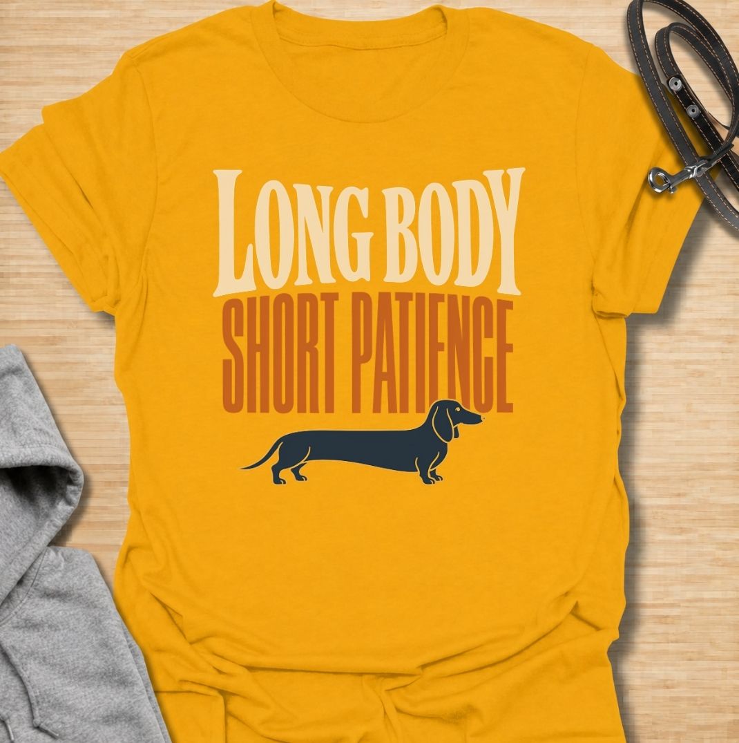 For dachshunds blessed with an impressively long body and a remarkably limited supply of patience. This funny dachshund T-shirt features the phrase “Long Body, Short Patience” with a clean vintage-inspired sausage dog illustration. Perfect for doxie owners who know stubbornness, impatience and plenty of attitude all come with those tiny legs. A bold dog lover tee that captures classic dachshund personality without taking itself too seriously.