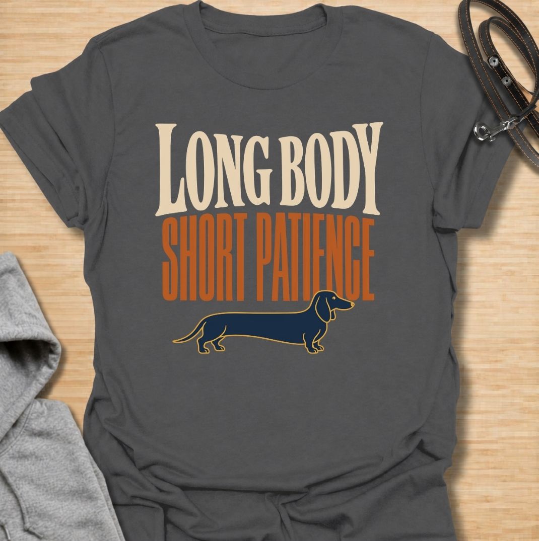 For dachshunds blessed with an impressively long body and a remarkably limited supply of patience. This funny dachshund T-shirt features the phrase “Long Body, Short Patience” with a clean vintage-inspired sausage dog illustration. Perfect for doxie owners who know stubbornness, impatience and plenty of attitude all come with those tiny legs. A bold dog lover tee that captures classic dachshund personality without taking itself too seriously.