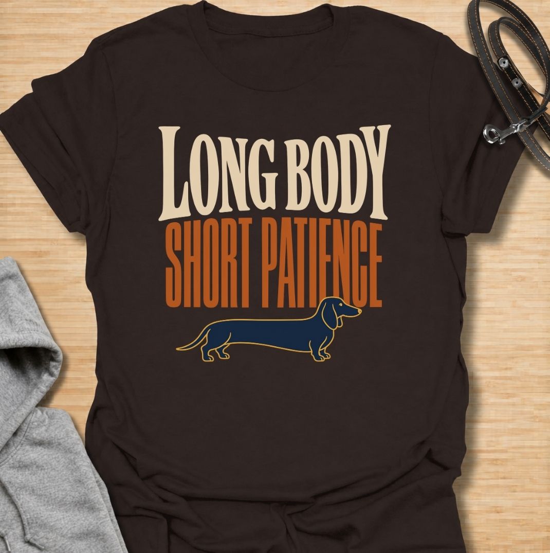 For dachshunds blessed with an impressively long body and a remarkably limited supply of patience. This funny dachshund T-shirt features the phrase “Long Body, Short Patience” with a clean vintage-inspired sausage dog illustration. Perfect for doxie owners who know stubbornness, impatience and plenty of attitude all come with those tiny legs. A bold dog lover tee that captures classic dachshund personality without taking itself too seriously.